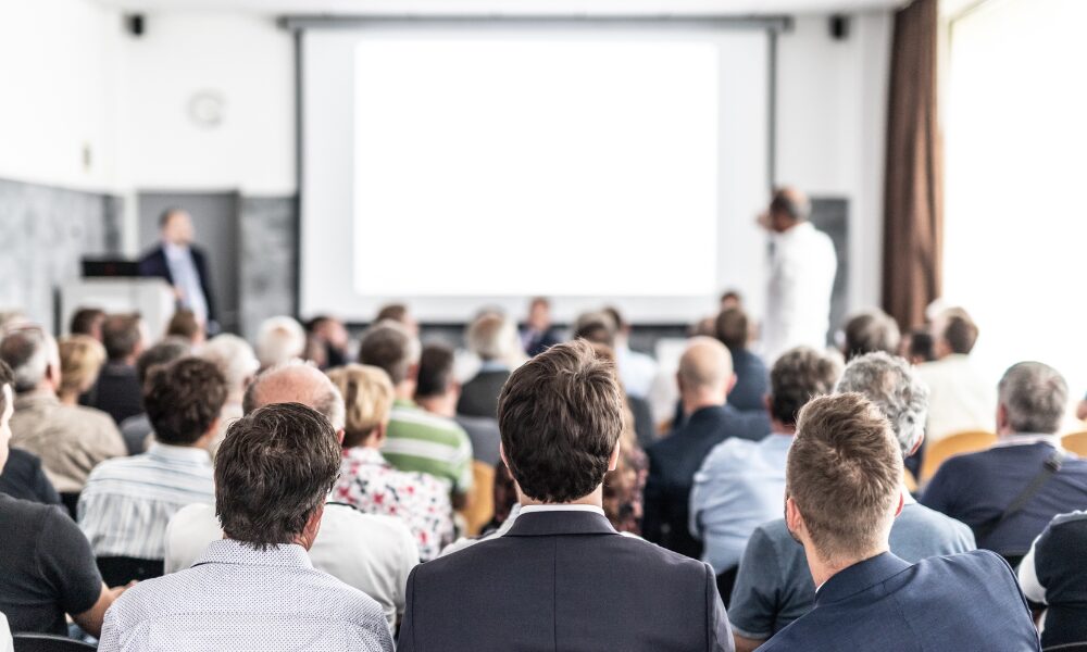 Alt-text- Bilingual administrative assistant handling calls and emails graphic.